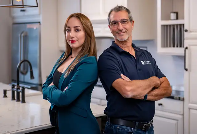 Designer Reem Kader and owner Steve Tedesco in a white kitchen at Stevens Kitchens