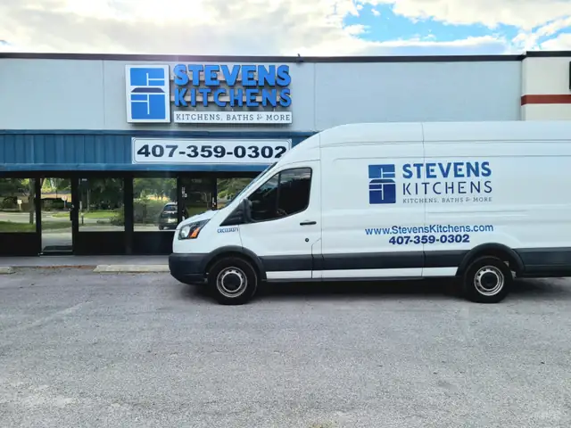 Stevens Kitchens showroom building with its blue sign and a branded white company van in front
